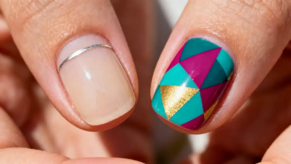 Minimalist nail design contrasted with bold geometric nail art
